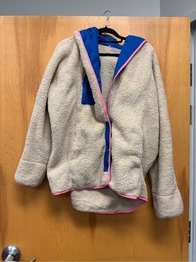 Amazon Cream Sherpa Jacket with Blue Collar and Pink Trim Accents